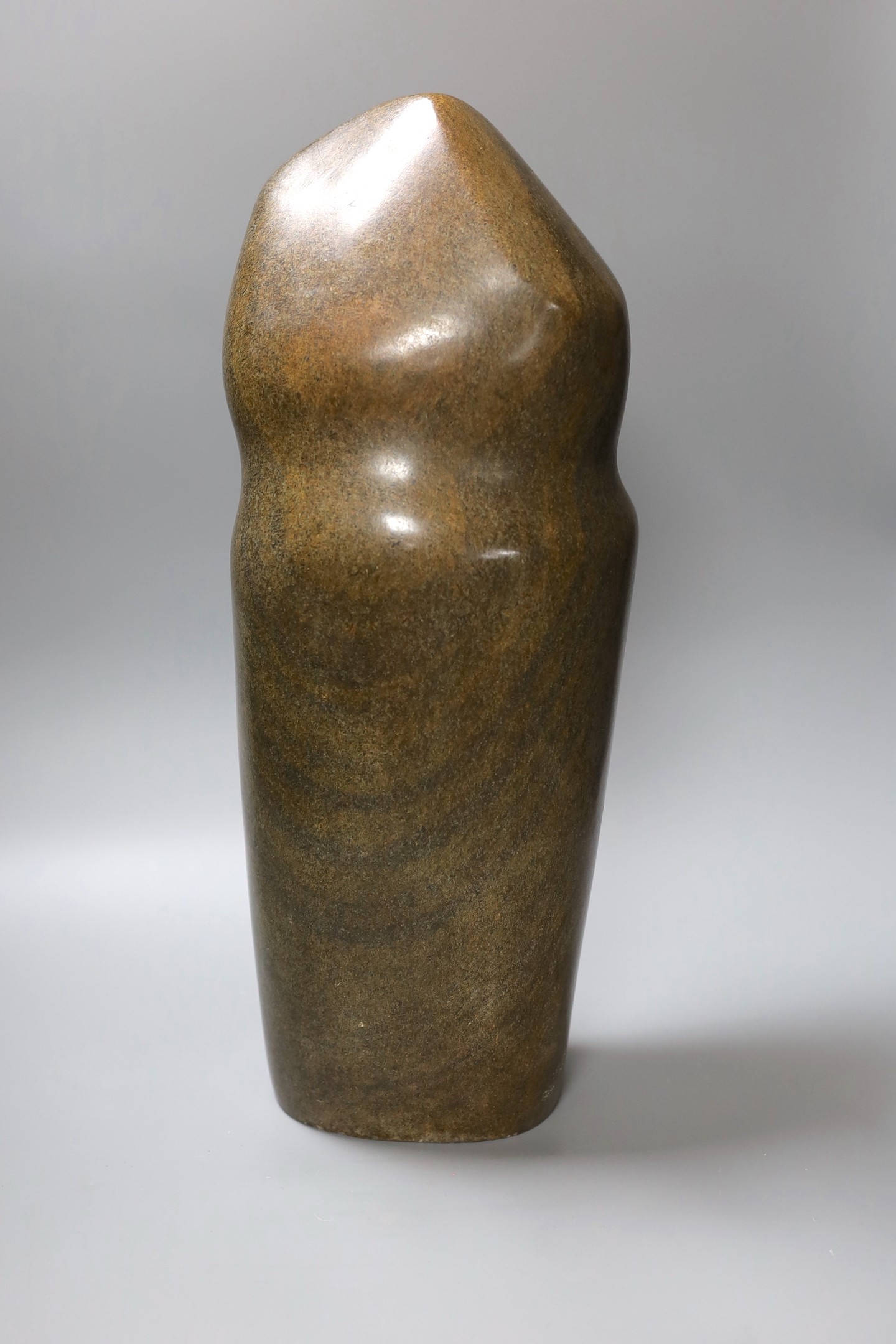 A Zimbabwean carved and polished stone slender abstract figure, 48cm tall